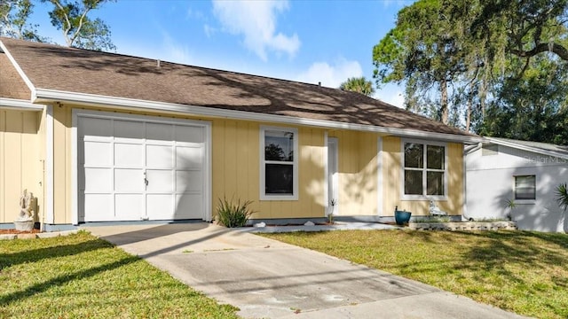 ranch-style house with a garage and a front yard