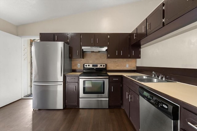 kitchen featuring lofted ceiling, sink, dark hardwood / wood-style flooring, stainless steel appliances, and dark brown cabinets