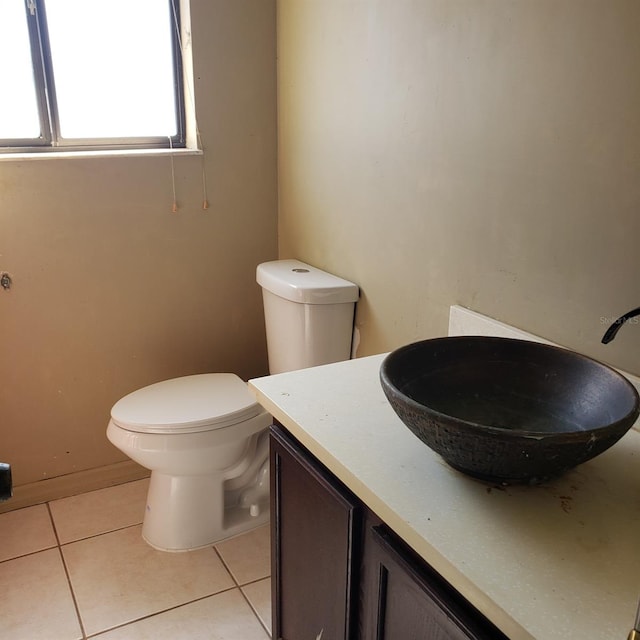 bathroom featuring vanity, toilet, and tile patterned flooring