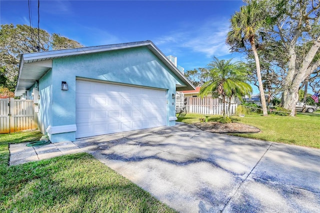 view of front of home with a garage and a front lawn