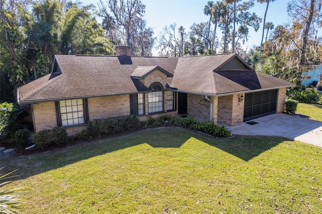 ranch-style home featuring a garage and a front lawn