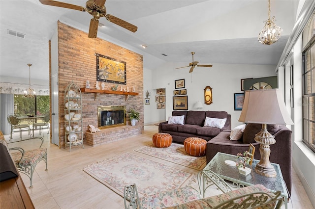 living room with lofted ceiling, a brick fireplace, ceiling fan with notable chandelier, and light tile patterned floors