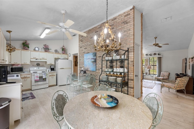 dining area featuring high vaulted ceiling, brick wall, and ceiling fan with notable chandelier