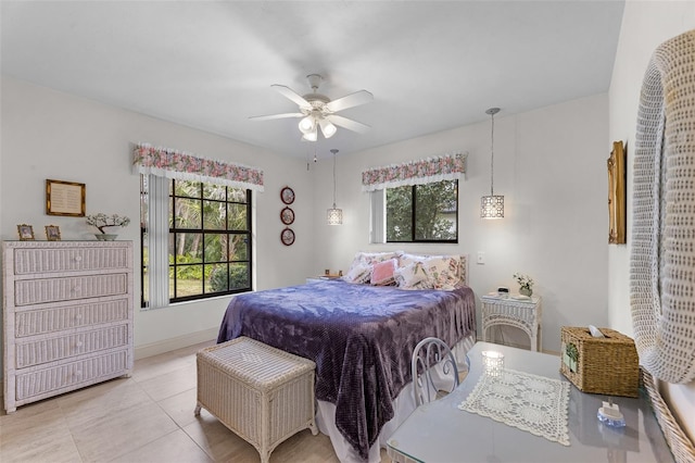 bedroom with ceiling fan, multiple windows, and light tile patterned floors