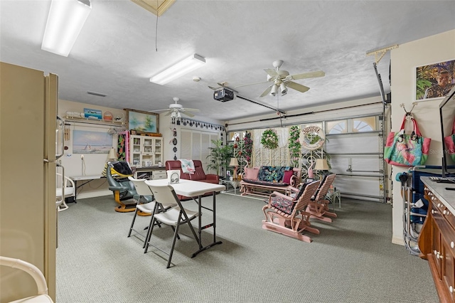 garage featuring ceiling fan and a garage door opener