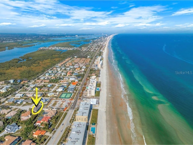 drone / aerial view featuring a water view and a beach view