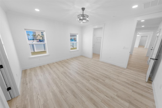 spare room with recessed lighting, a notable chandelier, visible vents, baseboards, and light wood-style floors