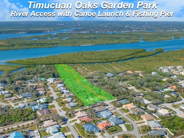 birds eye view of property with a water view and a residential view