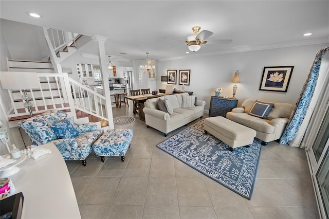 tiled living room with ornamental molding and ceiling fan with notable chandelier