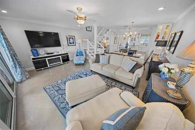 tiled living room with ornamental molding and ceiling fan with notable chandelier