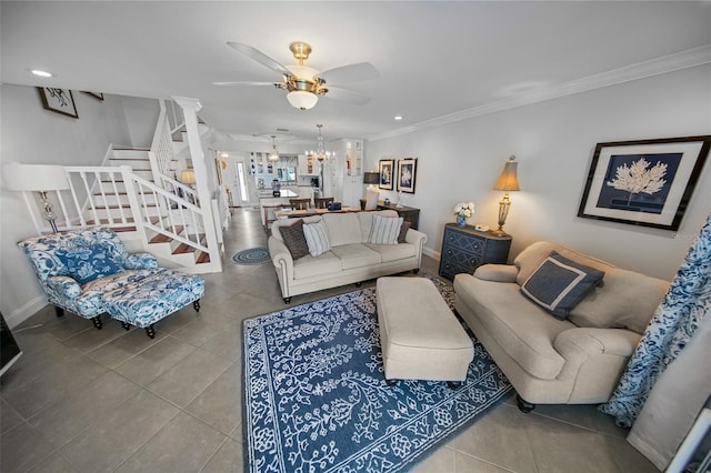 living room featuring ceiling fan with notable chandelier, ornamental molding, and tile patterned flooring