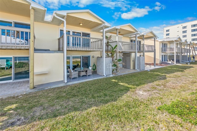 back of house featuring a yard and a patio area