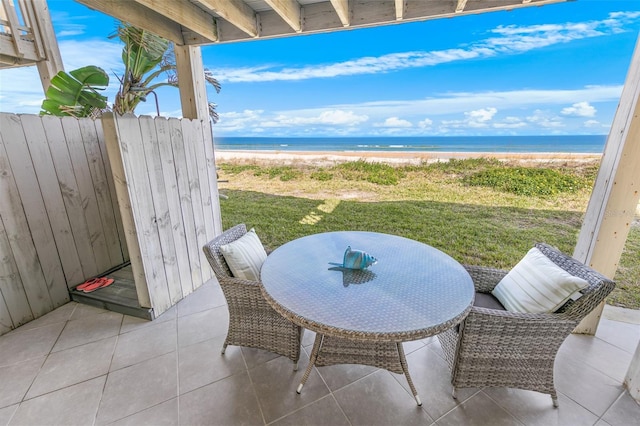 view of patio with a view of the beach and a water view