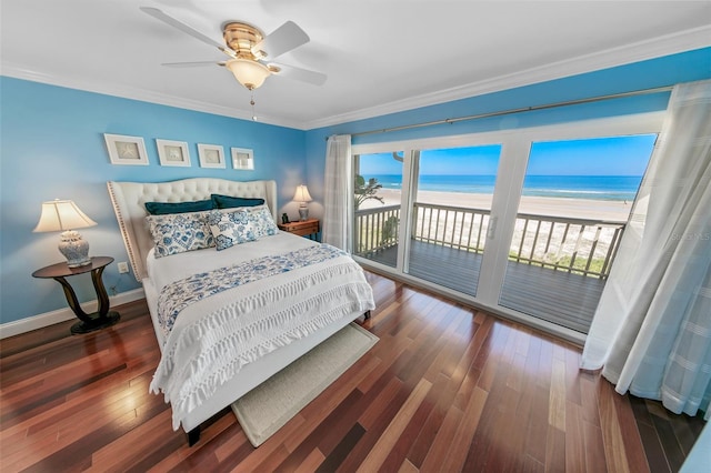 bedroom featuring a view of the beach, dark wood-type flooring, a water view, access to outside, and ornamental molding