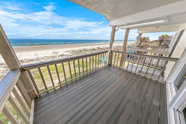 wooden terrace with a beach view and a water view