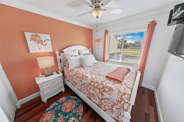 bedroom featuring ornamental molding, dark wood-type flooring, and ceiling fan