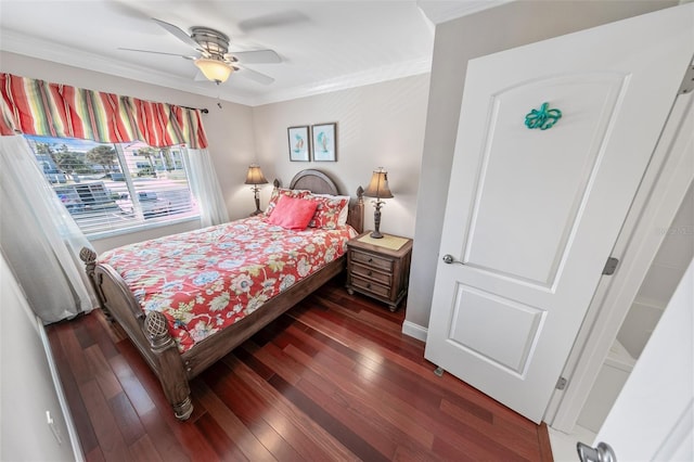 bedroom featuring ceiling fan, ornamental molding, and dark hardwood / wood-style flooring