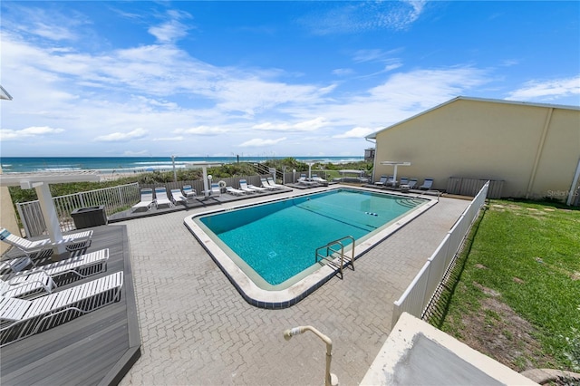 view of swimming pool with a patio and a water view