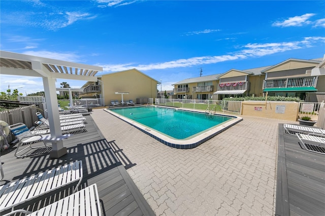 view of pool with a pergola and a patio