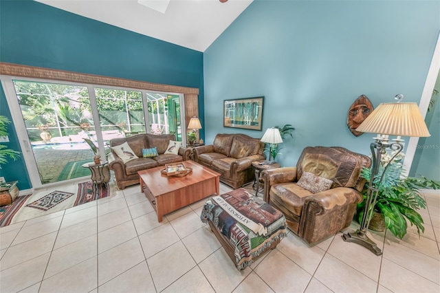 living room featuring high vaulted ceiling and light tile patterned floors