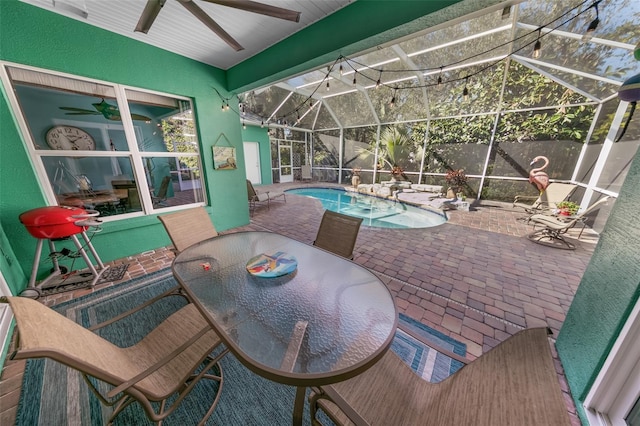 view of patio / terrace featuring ceiling fan and a lanai