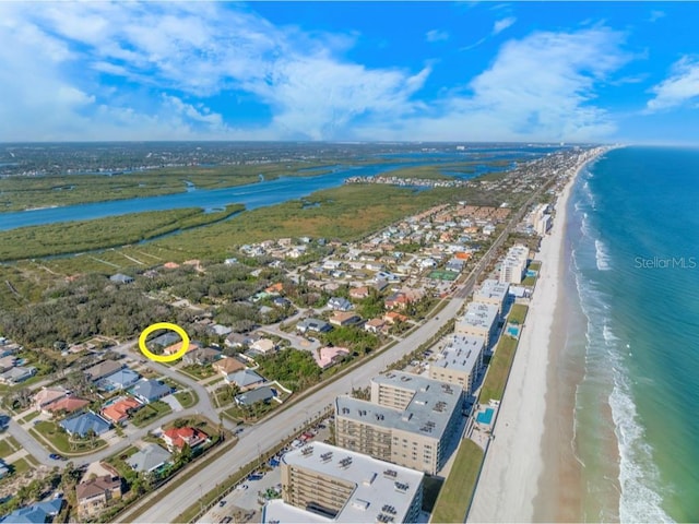 bird's eye view with a water view and a view of the beach