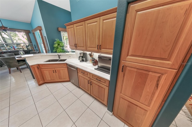 kitchen featuring light tile patterned flooring, sink, stainless steel dishwasher, and kitchen peninsula