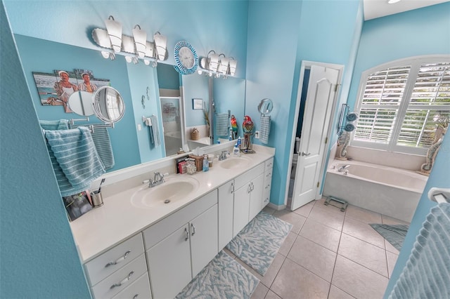 bathroom with vanity, a bathtub, and tile patterned floors