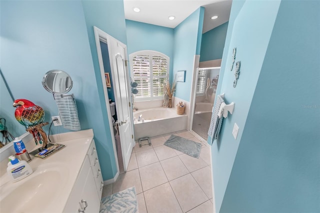 bathroom featuring vanity, tile patterned floors, and plus walk in shower