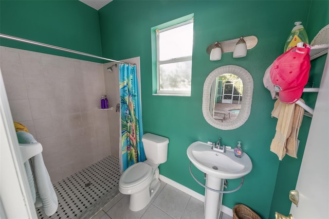 bathroom with a shower with curtain, tile patterned floors, and toilet