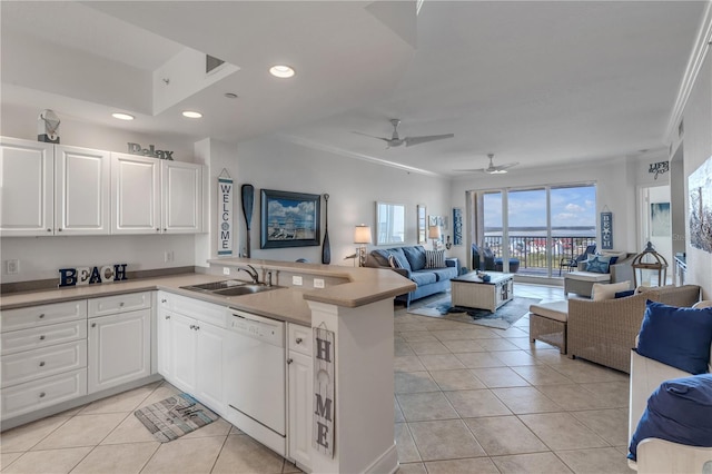 kitchen featuring white dishwasher, sink, white cabinetry, and kitchen peninsula