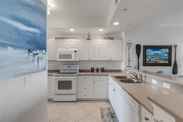 kitchen featuring white cabinetry, sink, light tile patterned flooring, and white appliances