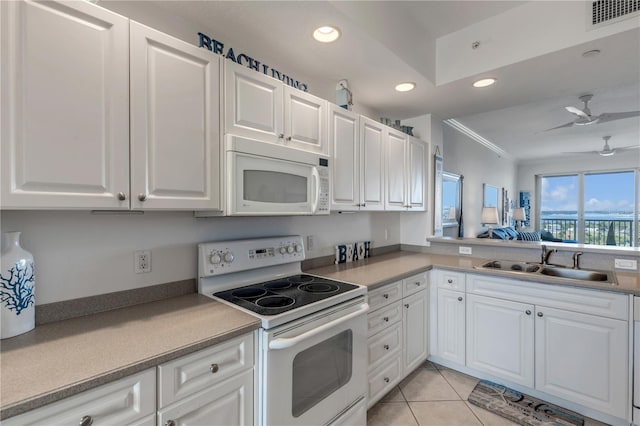 kitchen with sink, white appliances, ceiling fan, white cabinets, and light tile patterned flooring