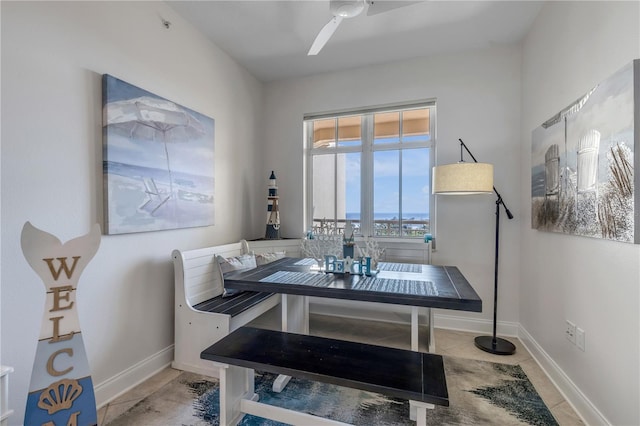 tiled dining space with ceiling fan