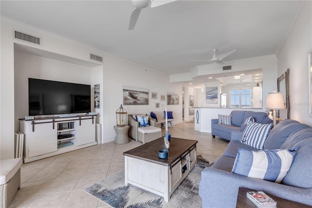 living room with light tile patterned floors, crown molding, and ceiling fan