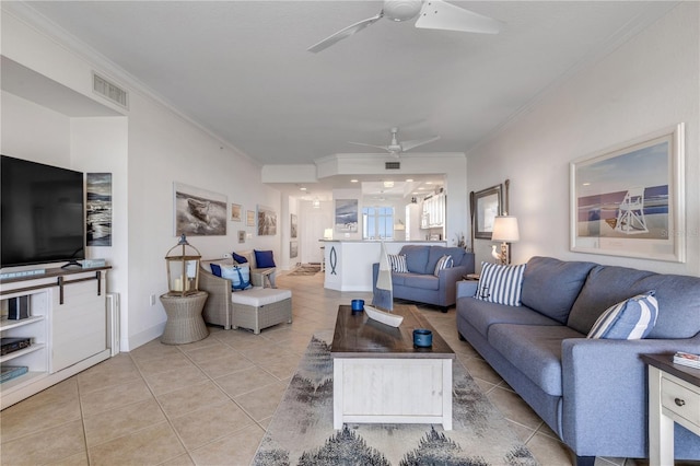 tiled living room with ornamental molding and ceiling fan