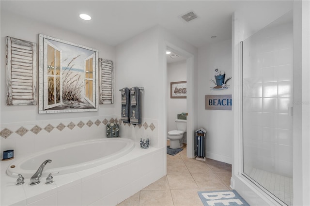 bathroom with tile patterned flooring, shower with separate bathtub, and toilet