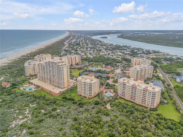 bird's eye view with a water view and a beach view