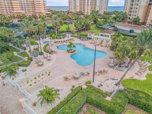 view of swimming pool with a patio, a water view, and a pergola