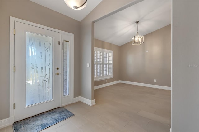 foyer entrance with vaulted ceiling and a notable chandelier