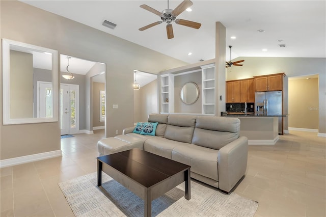 living room with light tile patterned flooring, ceiling fan, and lofted ceiling