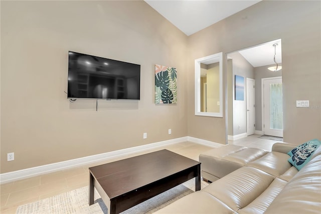 living room featuring lofted ceiling and light tile patterned floors