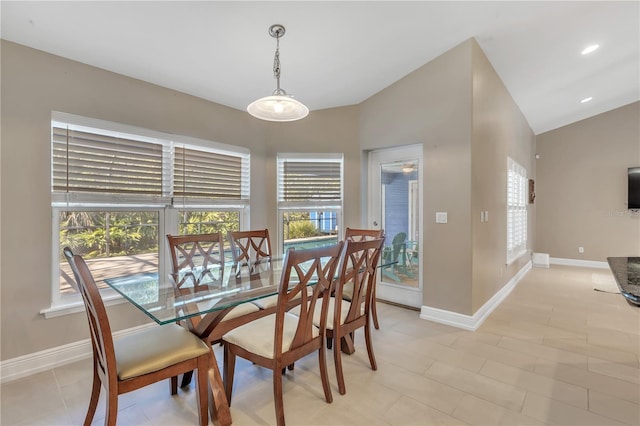 tiled dining room featuring lofted ceiling