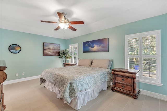 bedroom featuring multiple windows and ceiling fan