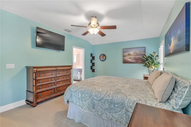 bedroom featuring lofted ceiling, light tile patterned floors, and ceiling fan