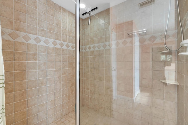 bathroom with tiled shower