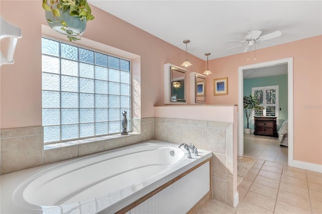 bathroom with ceiling fan, tiled bath, and tile patterned flooring