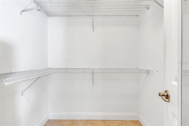 spacious closet featuring light tile patterned floors