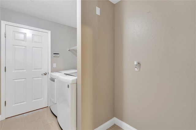 laundry area featuring light tile patterned floors and independent washer and dryer