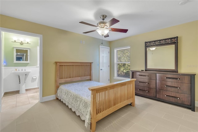 tiled bedroom featuring ceiling fan and ensuite bathroom